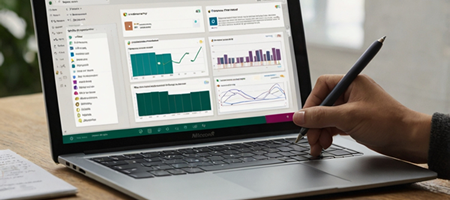 A business user designing a Microsoft Forms survey on a laptop, with survey questions and response charts visible.